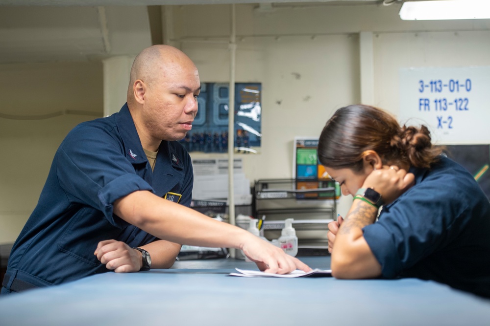 U.S. Navy Sailor Helps Sailor File Paperwork