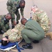 Airmen collaborate with Rwandan Armed Forces in an exercise to load simulated patients onto an aircraft for UN deployment