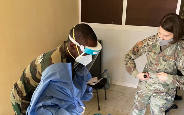 Airmen assist Senegalese Armed Forces with the sequence for putting on and taking off personal protective equipment