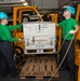 Sailors Stabilize Cargo During Hoist Operations