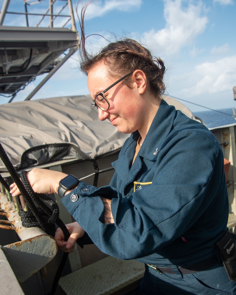 Sailor Prepares To Raise Signal Flag