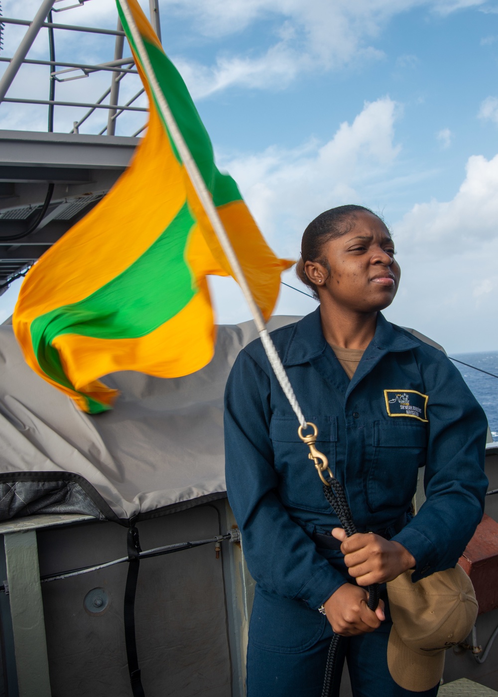 Sailor Prepares To Raise Signal Flag