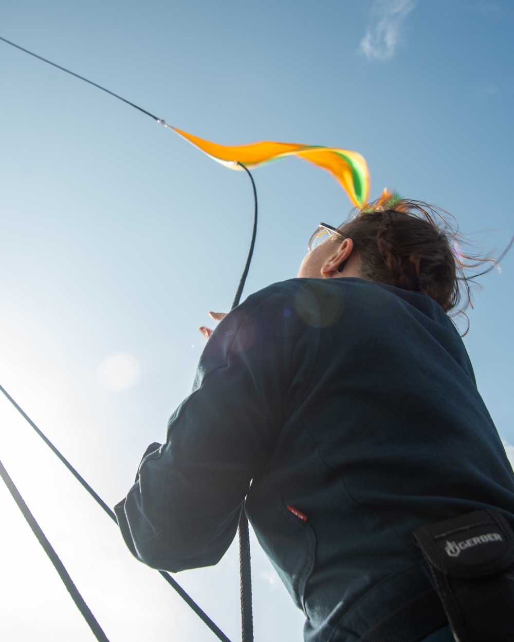 Sailor Prepares To Raise Signal Flag