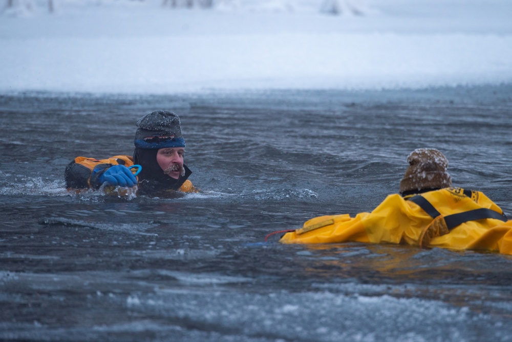 JBER firefighters take a plunge for ice water rescue training