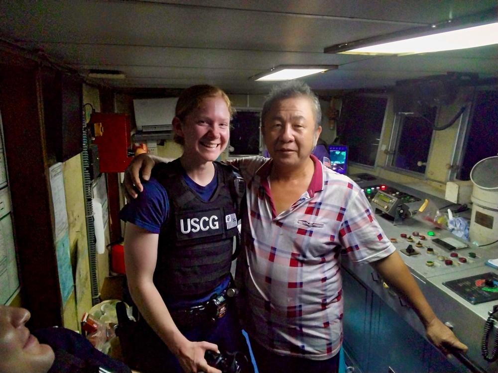 U.S. Coast Guard boarding officer takes a moment for photo with fishing vessel captain