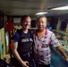 U.S. Coast Guard boarding officer takes a moment for photo with fishing vessel captain