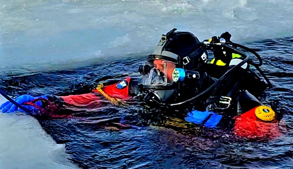 Firefighters on installation fire department dive team participate in ice rescue training at frozen lake at Fort McCoy