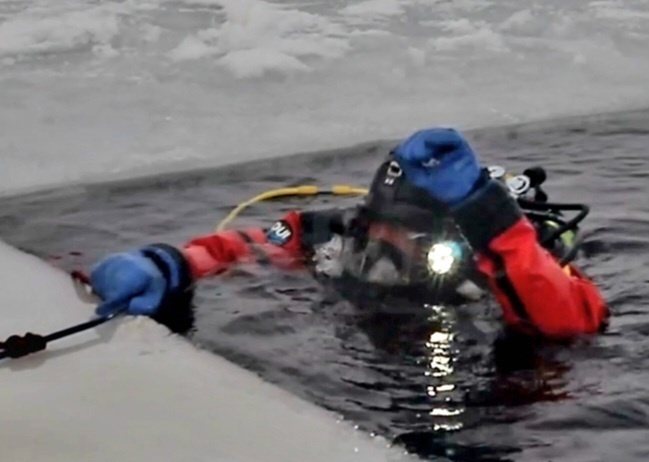 Firefighters on installation fire department dive team participate in ice rescue training at frozen lake at Fort McCoy