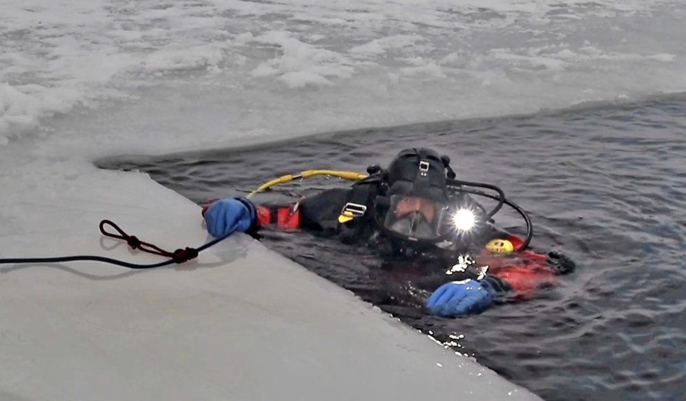 Firefighters on installation fire department dive team participate in ice rescue training at frozen lake at Fort McCoy