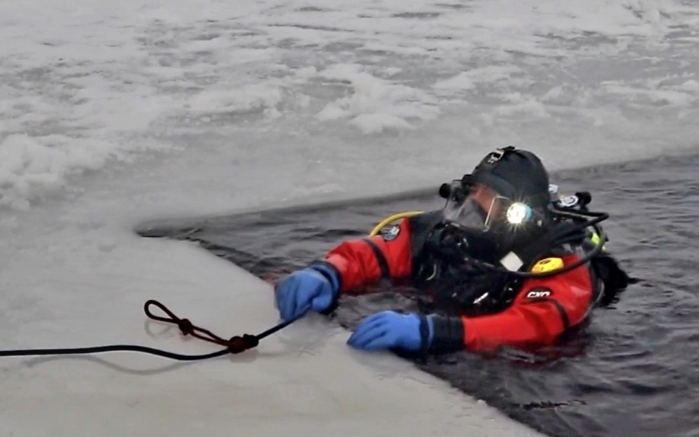 Firefighters on installation fire department dive team participate in ice rescue training at frozen lake at Fort McCoy