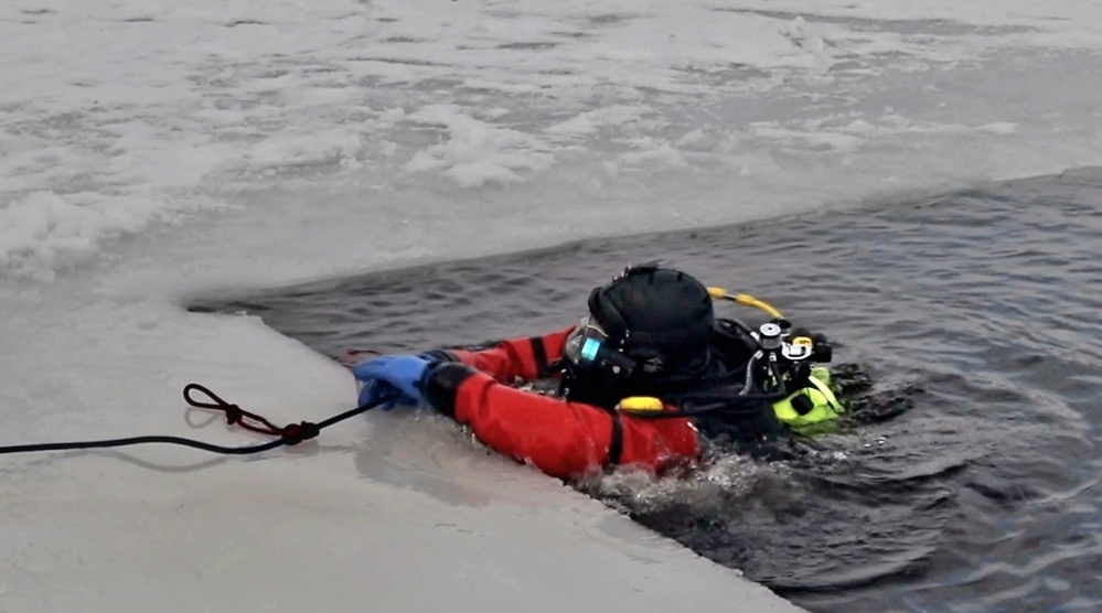 Firefighters on installation fire department dive team participate in ice rescue training at frozen lake at Fort McCoy