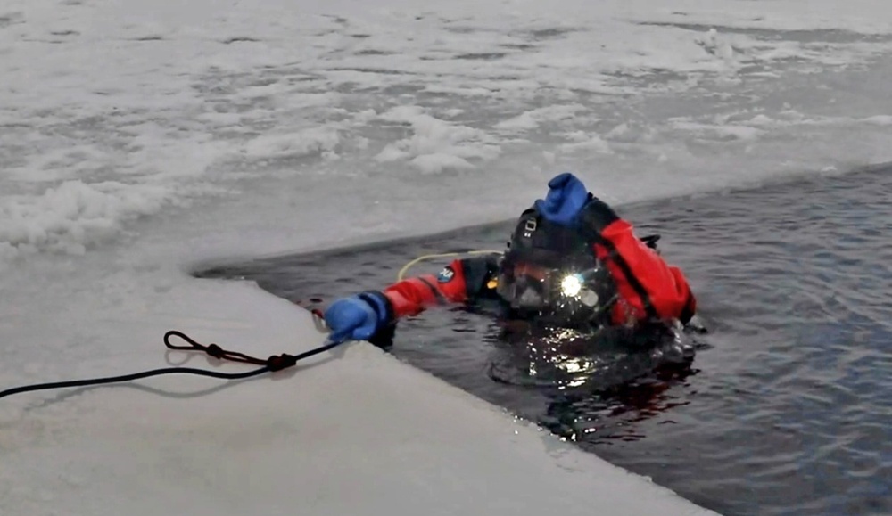 Firefighters on installation fire department dive team participate in ice rescue training at frozen lake at Fort McCoy