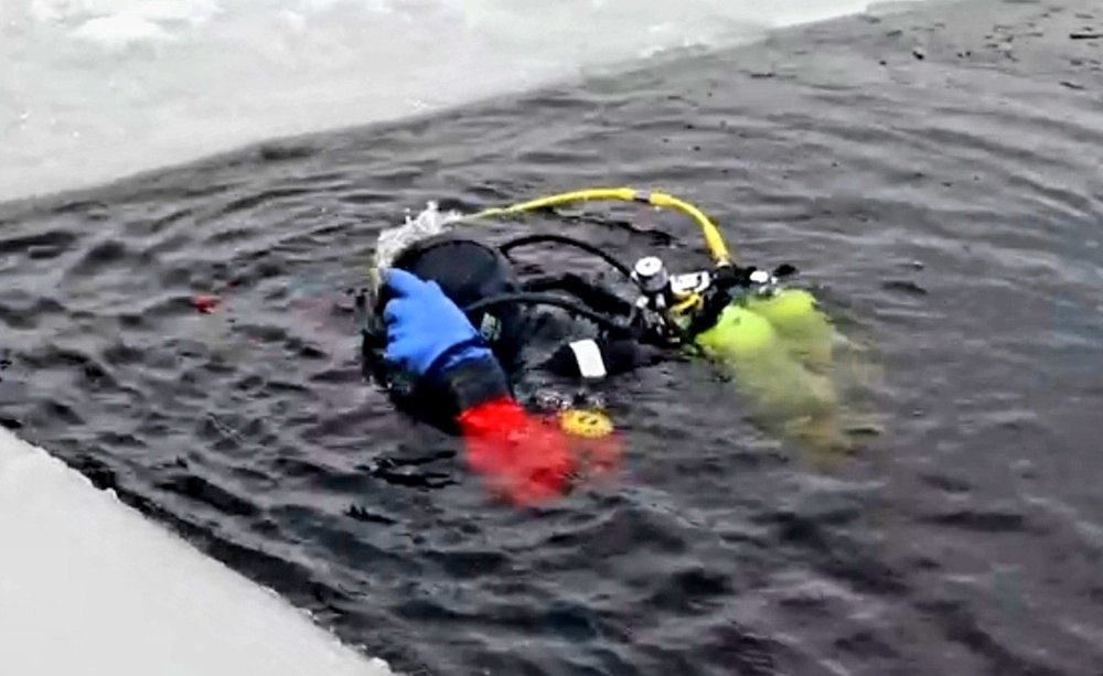 Firefighters on installation fire department dive team participate in ice rescue training at frozen lake at Fort McCoy