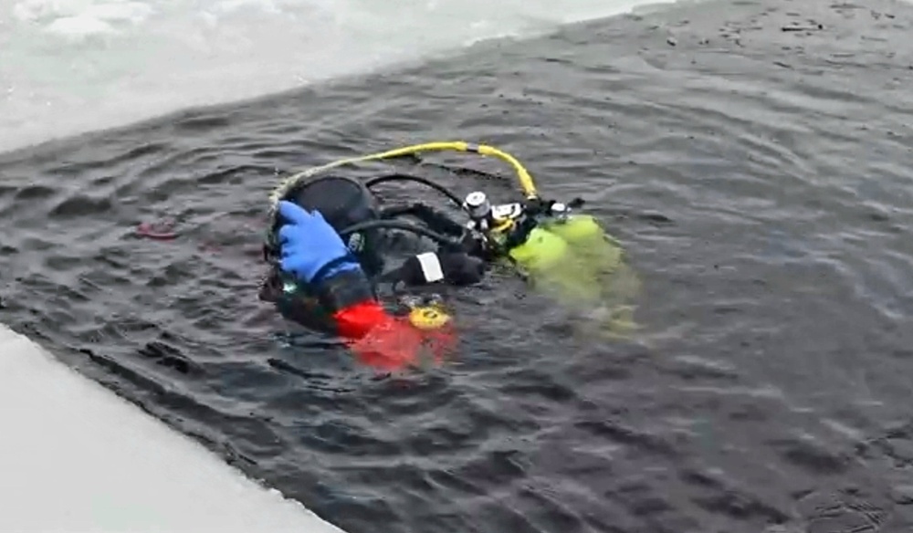 Firefighters on installation fire department dive team participate in ice rescue training at frozen lake at Fort McCoy