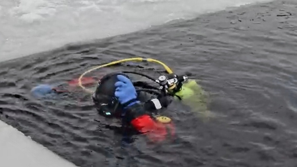 Firefighters on installation fire department dive team participate in ice rescue training at frozen lake at Fort McCoy