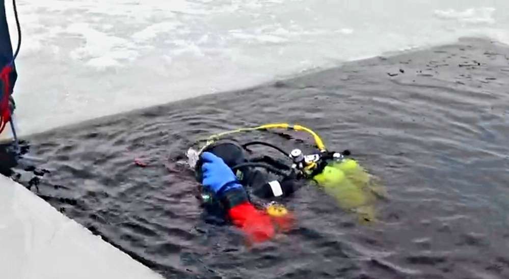 Firefighters on installation fire department dive team participate in ice rescue training at frozen lake at Fort McCoy