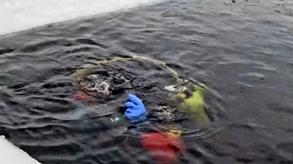 Firefighters on installation fire department dive team participate in ice rescue training at frozen lake at Fort McCoy