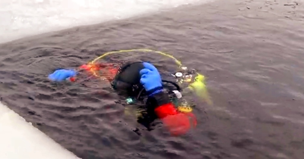 Firefighters on installation fire department dive team participate in ice rescue training at frozen lake at Fort McCoy