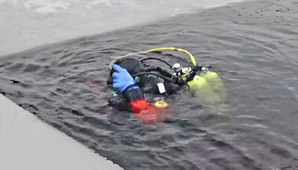 Firefighters on installation fire department dive team participate in ice rescue training at frozen lake at Fort McCoy