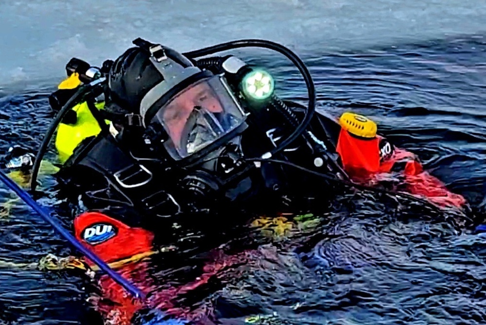 Firefighters on installation fire department dive team participate in ice rescue training at frozen lake at Fort McCoy