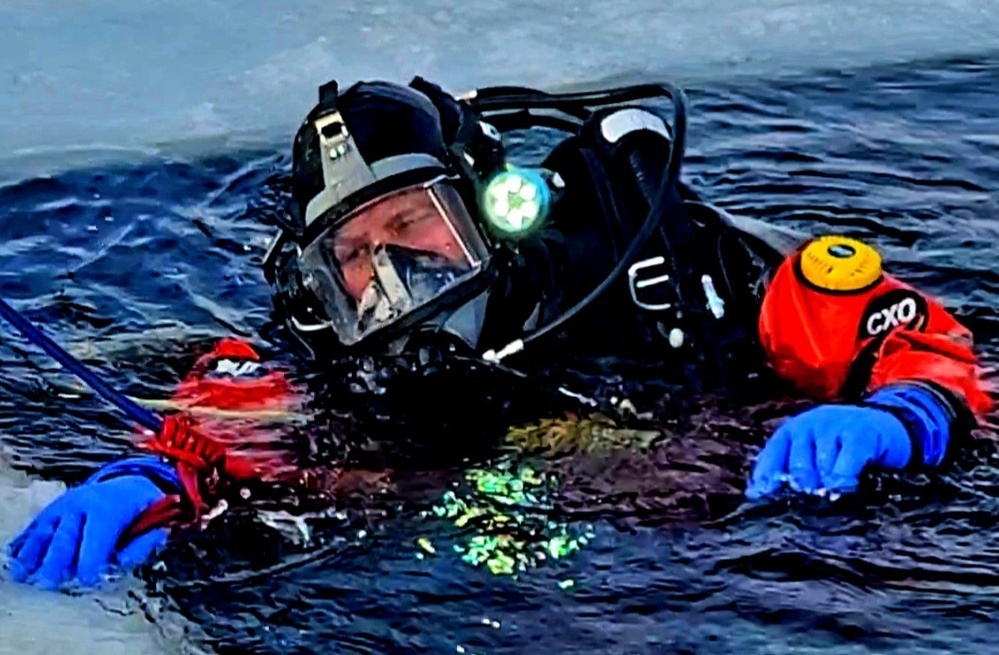 Firefighters on installation fire department dive team participate in ice rescue training at frozen lake at Fort McCoy