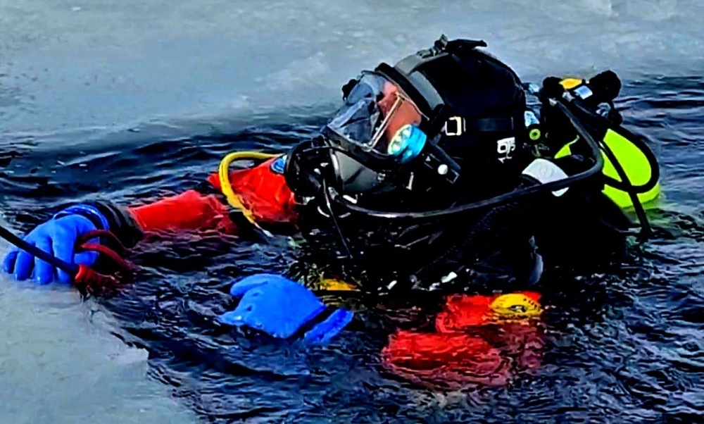 Firefighters on installation fire department dive team participate in ice rescue training at frozen lake at Fort McCoy