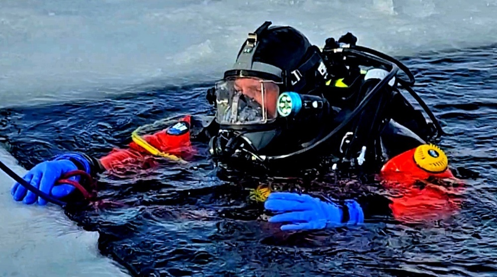 Firefighters on installation fire department dive team participate in ice rescue training at frozen lake at Fort McCoy