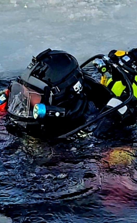 Firefighters on installation fire department dive team participate in ice rescue training at frozen lake at Fort McCoy