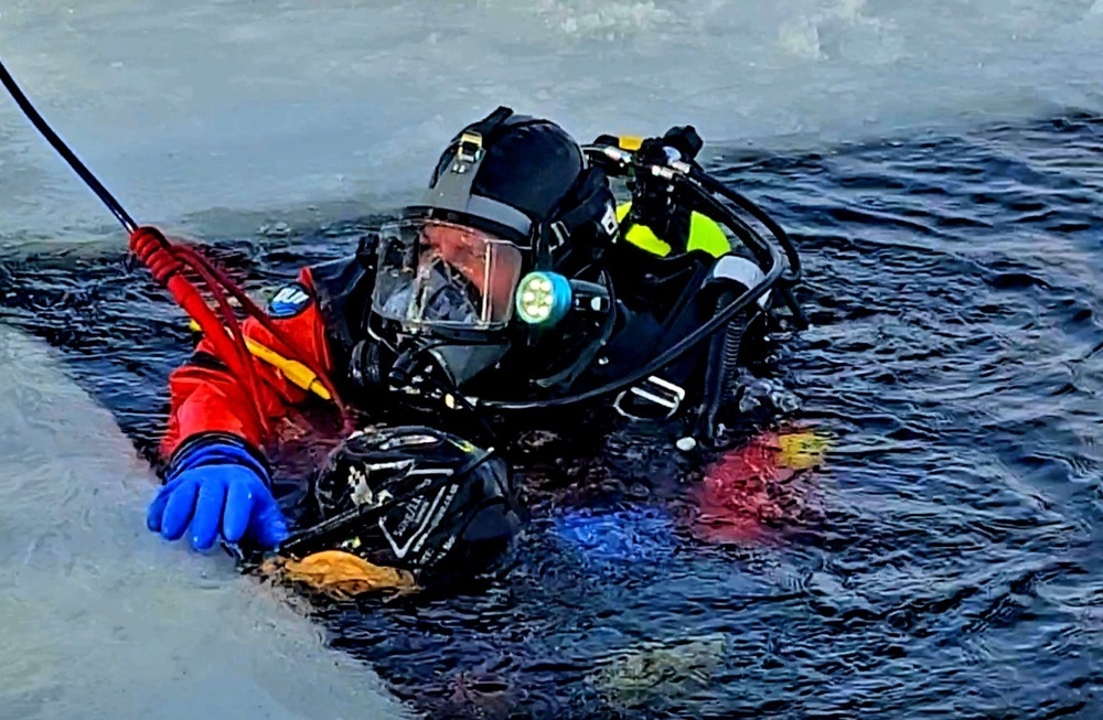 Firefighters on installation fire department dive team participate in ice rescue training at frozen lake at Fort McCoy