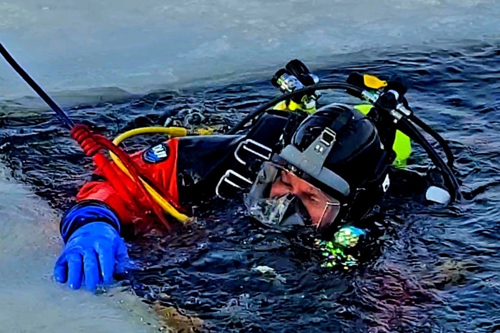 Firefighters on installation fire department dive team participate in ice rescue training at frozen lake at Fort McCoy