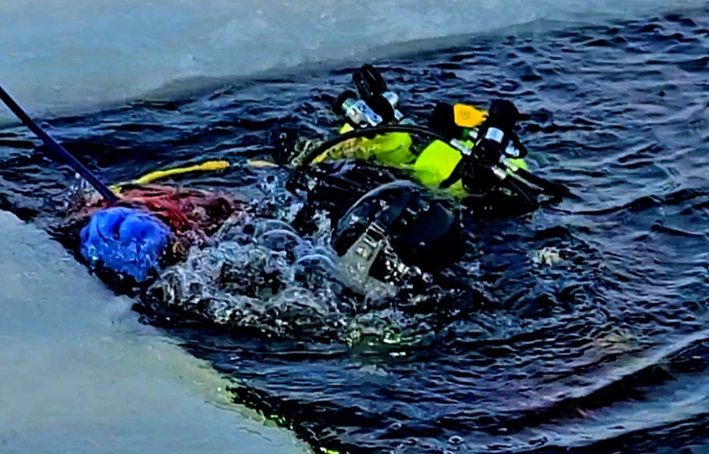 Firefighters on installation fire department dive team participate in ice rescue training at frozen lake at Fort McCoy