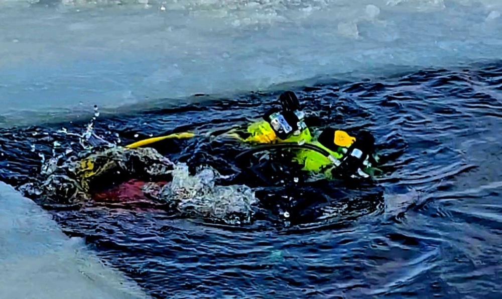 Firefighters on installation fire department dive team participate in ice rescue training at frozen lake at Fort McCoy