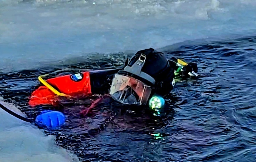 Firefighters on installation fire department dive team participate in ice rescue training at frozen lake at Fort McCoy