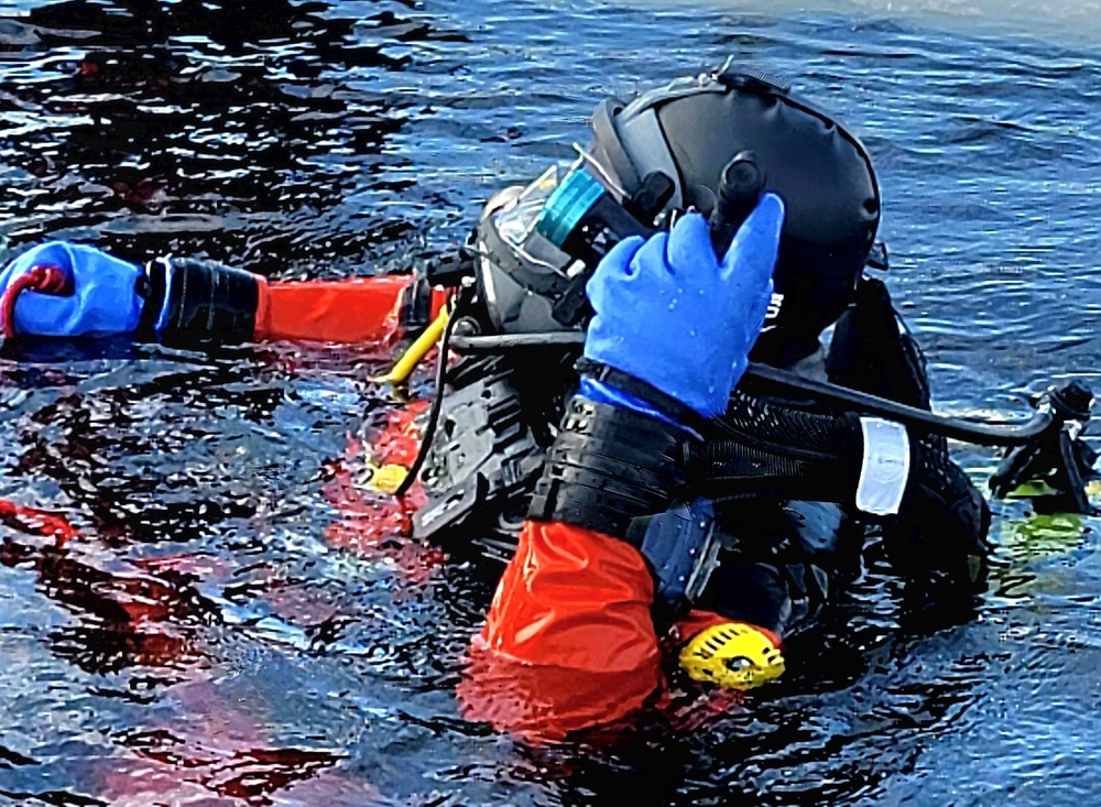 Firefighters on installation fire department dive team participate in ice rescue training at frozen lake at Fort McCoy