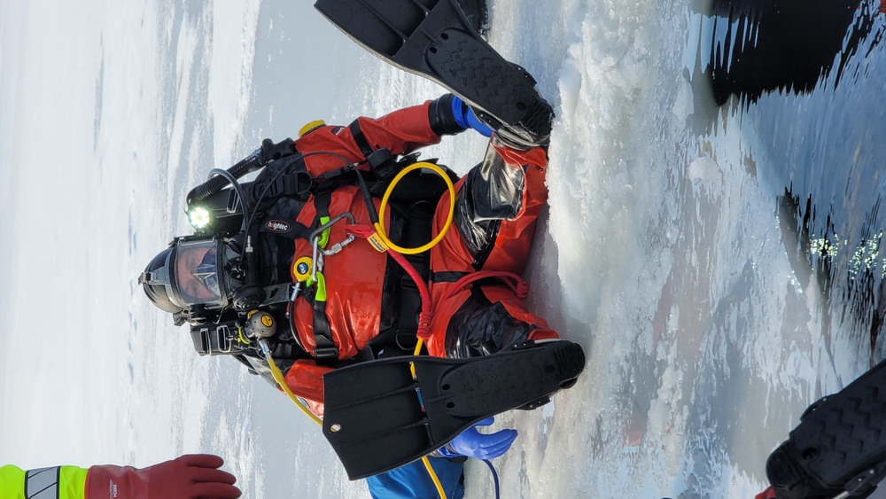 Firefighters on installation fire department dive team participate in ice rescue training at frozen lake at Fort McCoy