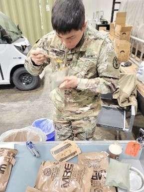 Sgt. Jose Jimenez, veterinary food inspector at Public Health Activity- Rheinland Pfalz, sampling the pepperoni pizza, which are part of the MREs for the U.S. Marine Corps Prepositioning Program-Norway, to assess if a shelf-life extension can be granted.