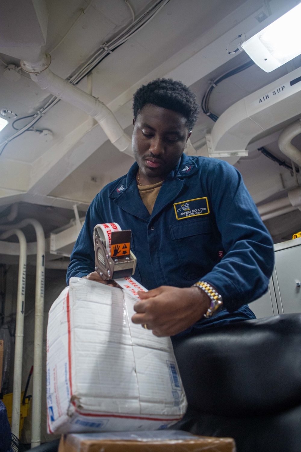 U.S. Navy Sailor Tapes Secures A Package