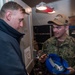 USS Ronald Reagan (CVN 76) Sailors issue personal protective equipment