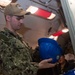 USS Ronald Reagan (CVN 76) Sailors issue personal protective equipment