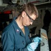 Sailor Applies Adhesive To Aircraft Panel