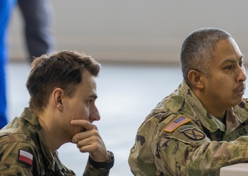 U.S. Army Staff Sgt goes over maintenance protocol with Polish military