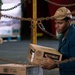 USS Carl Vinson (CVN-70) Sailor Participates In Stores Onload