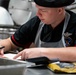 USS Carl Vinson (CVN-70) Sailor Prepares For Meal