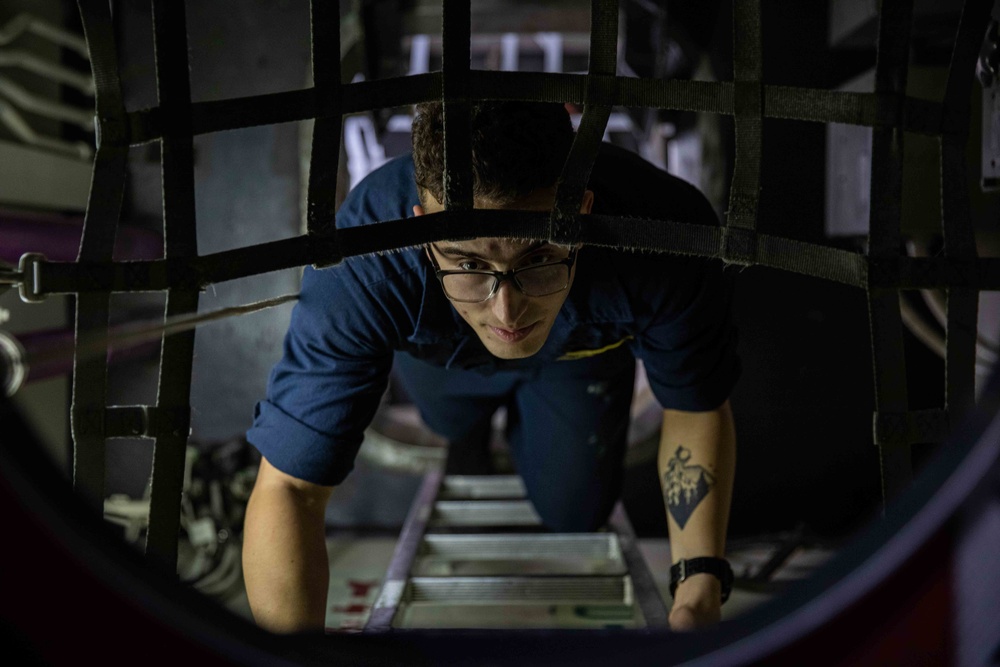 U.S. Sailor Travels Down Ladder