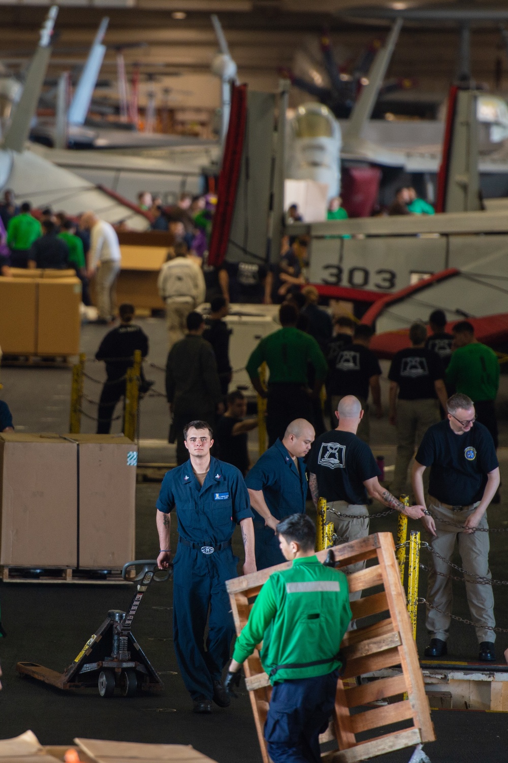 U.S. Navy Sailors Move Cargo In Hangar Bay