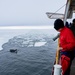 Coast Guard Cutter Polar Star (WAGB 10) receives a visit from some Orcas