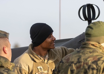 U.S. Army Soldier shows Polish military the AH-64 Apache