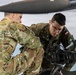 U.S Army Soldier shows Polish Military an AH-64 Apache