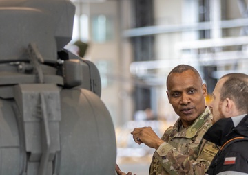 U.S Army Soldier shows Polish Military an AH-64 Apache