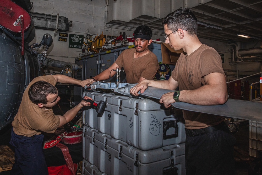 Sailors Perform Maintenance on Outboard Tension Plate